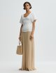 Темно-бежевые брюки By Malene Birger свободного кроя: фото 1 - Invogue