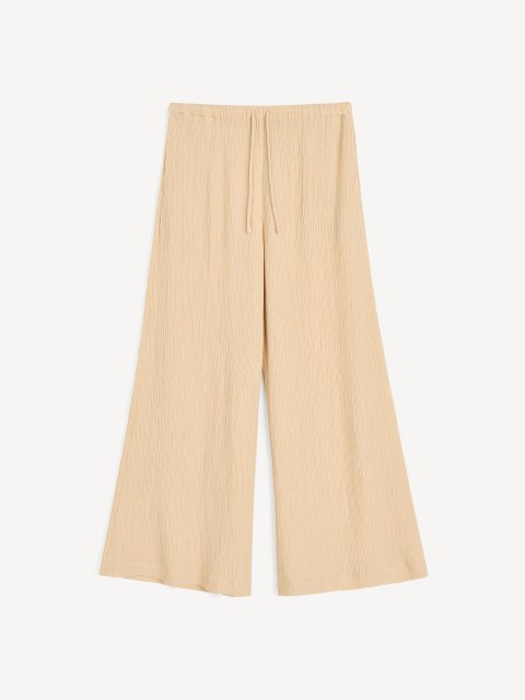 Темно-бежевые брюки By Malene Birger свободного кроя: фото - Invogue
